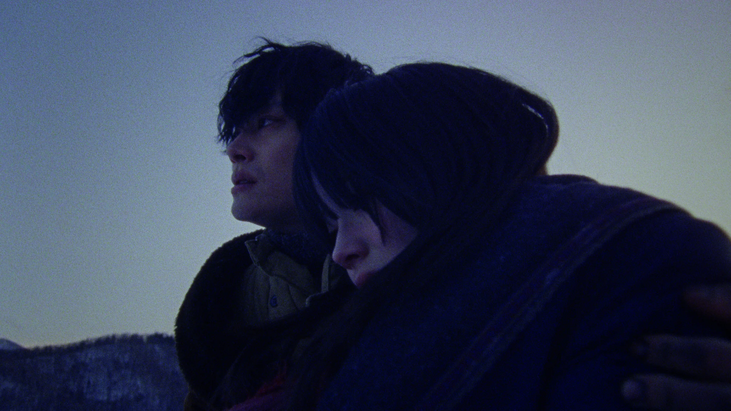 A young man and woman together in the snow